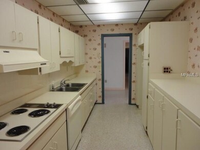 Galley kitchen with plenty of cabinet space.  Opens up into living/dining room combo.