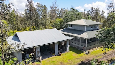 Three-car detached garage is behind the home with ample room for maneuvering