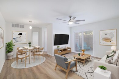 Living area with light wood-style flooring, baseb