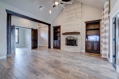 living room featuring a barn door, light hardwood 