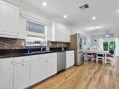 Kitchen with white cabinetry, light wood-style floors, appliances with stainless steel finishes, a ceiling fan, and recessed lighting