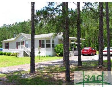 Exterior Front. Shady woods along driveway and thi