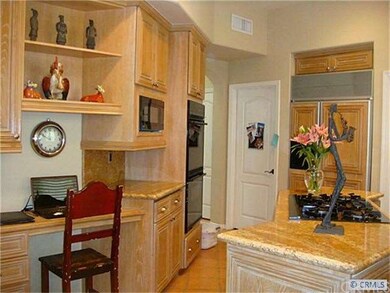 Two built-in ovens and microwave, working desk.