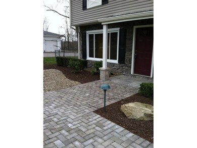 New walkway with pavers and landscaping.