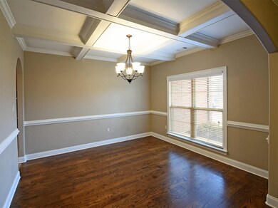 In this room the ceiling tells the story.  Formal white beams dress the ceiling for a truly beautiful look.