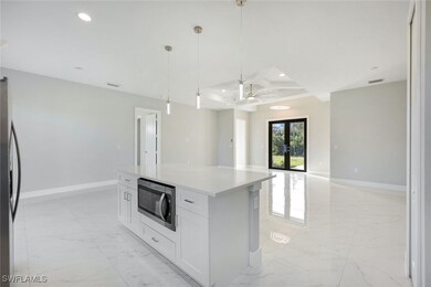 Kitchen featuring french doors, hanging light fixt