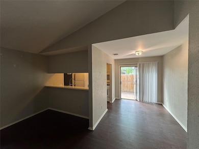 Empty room featuring vaulted ceiling, wood finish