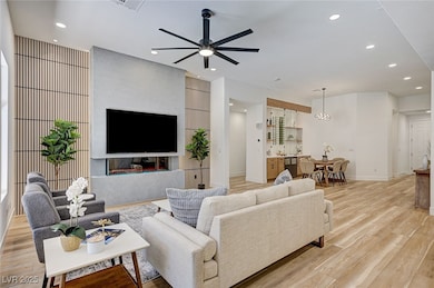 Living area with light wood finished floors, a cei