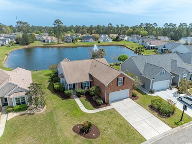 Birds eye view of property with a water view and a