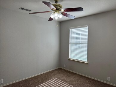 Carpeted spare room with ceiling fan