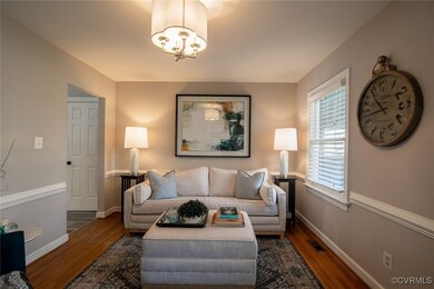 Living room with a chandelier, visible vents, base