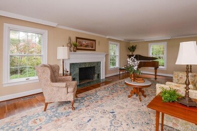 Huge living room with fireplace and one of many wa