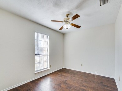 Empty room with dark wood-type flooring and ceilin