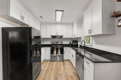 Kitchen has been updated with white cabinets and granite countertops