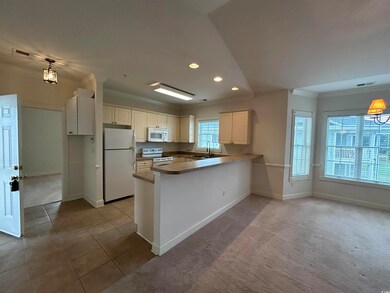 Kitchen featuring sink, kitchen peninsula, white a