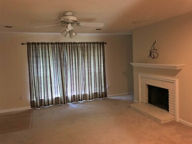 Theliving room is spacious and features a center f