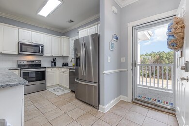Kitchen with light tile patterned flooring, applia