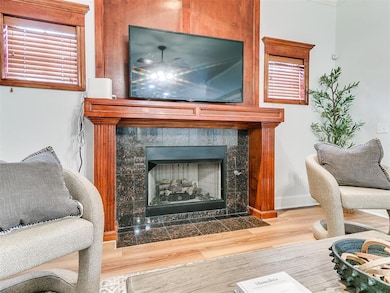 Detailed view of a fireplace and wood finished floors