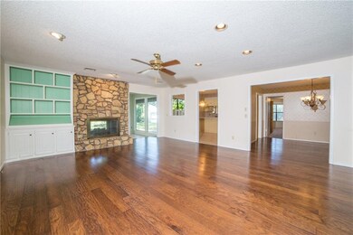 Wood floors extend into the dining room and hallwa