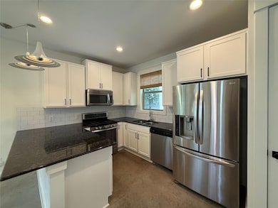 Kitchen featuring stainless steel appliances, whi