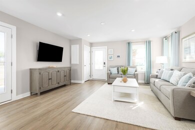 Living room with light hardwood / wood-style floor