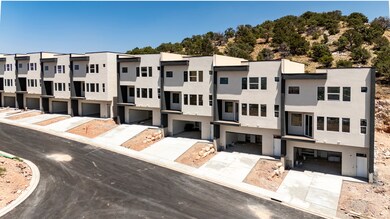 View of property featuring concrete driveway and a residential view