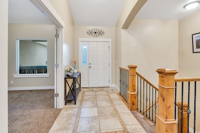 Looking at the Front door Entrance, with inlaid tile floor. Multipurpose room on the Left.