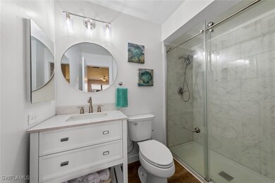 Ensuite primary bathroom featuring a shower stall,