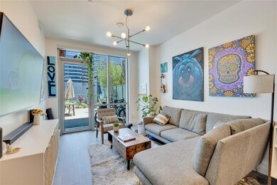 Living room with a chandelier and light wood fini