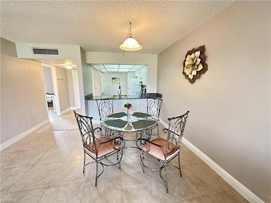 Dining room with sink, light tile patterned floors