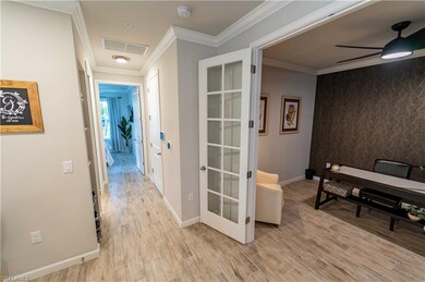Hallway featuring crown molding and light hardwood