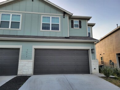 View of front facade with board and batten siding, concrete driveway, stone siding, roof with shingles, and a garage