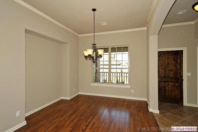 Dining room with wood floors, china hutch niche, a