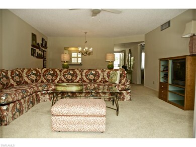 Great room looking toward kitchen and front door.