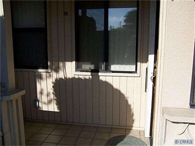 Front entry with small patio and storage room