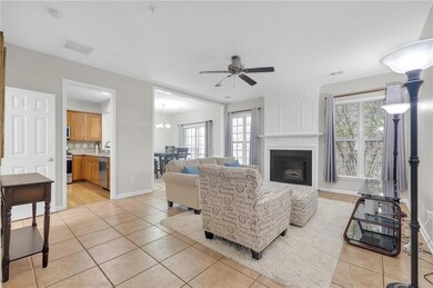 Living area with light tile patterned floors, healthy amount of natural light, and a fireplace