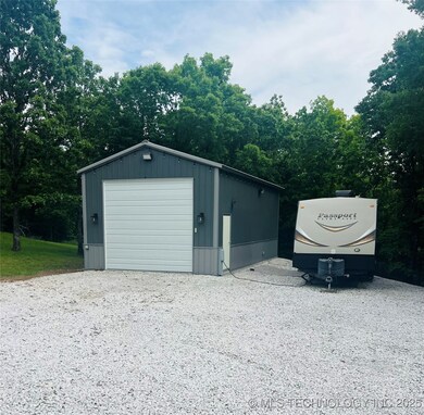 Detached garage with gravel driveway