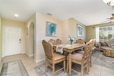 Dining space with arched walkways, light tile patterned floors, baseboards, ceiling fan, and recessed lighting