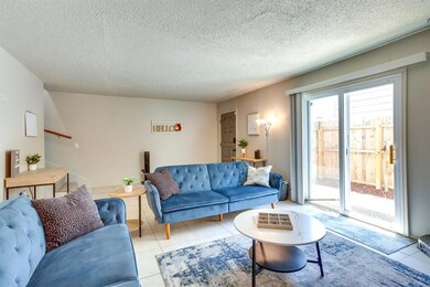 Tiled living room with a textured ceiling