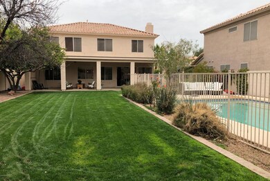 Grassy backyard/fenced pool area