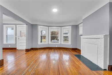 Unfurnished living room featuring a fireplace and hardwood / wood-style flooring