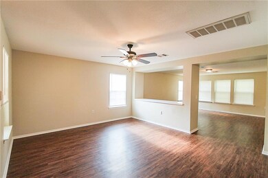 Unfurnished room with dark wood finished floors and ceiling fan