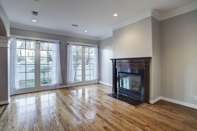 The Formal Living Room boasts beaming authentic Oak hardwood floors, 7 foot French windows, gas log fireplace, recessed lighting, crisp crown molding and more!