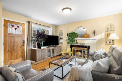 Living room with wood finished floors and a tile fireplace