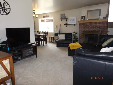 Living Room has a Brick faced  Log Burning Firepla