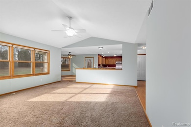 Open concept living room.  View of nature/trees