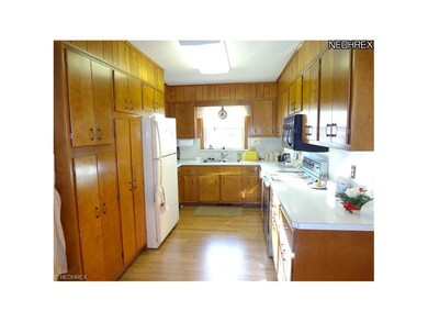 Fully applianced kitchen, wood laminate flooring.