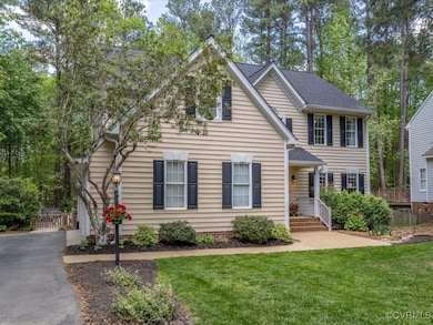 View of front of house featuring fence, driveway,