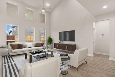 Gather the family and guests together in your lovely living room! Featuring high ceilings, recessed lighting, dark stained ceiling fan, custom paint, gorgeous floors and large windows that provide plenty of natural lighting throughout the day.
