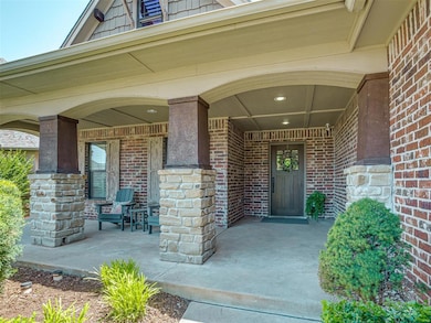 Large covered craftsman front porch with room for chairs and a swing bench.